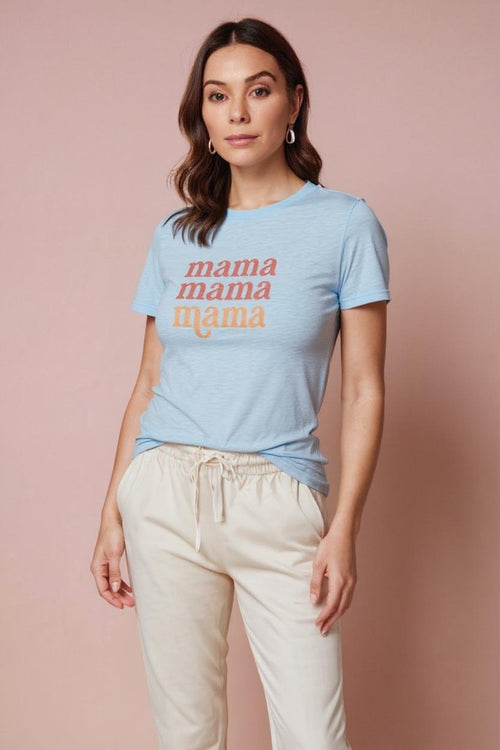 Woman wearing a light blue t-shirt with 'mama' text on a pink background