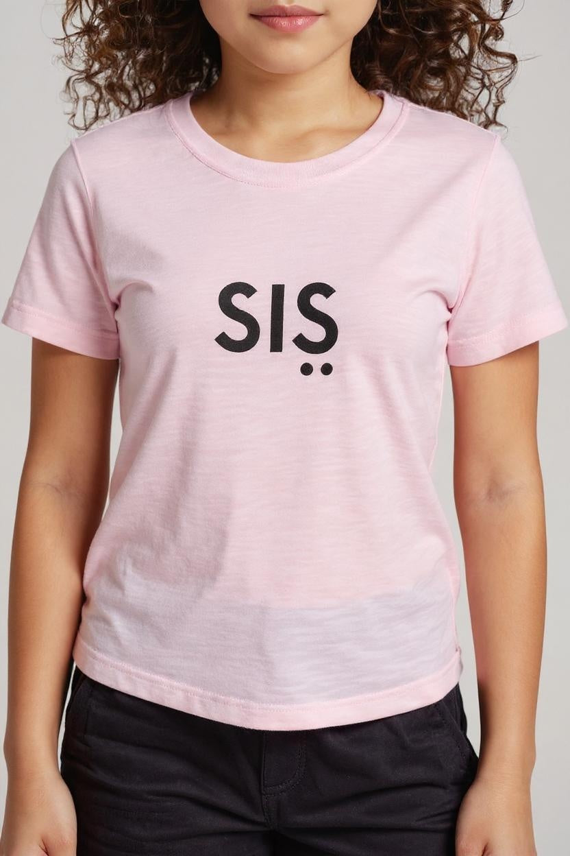 Person wearing a pink t-shirt with 'SIS' printed on it against a plain background