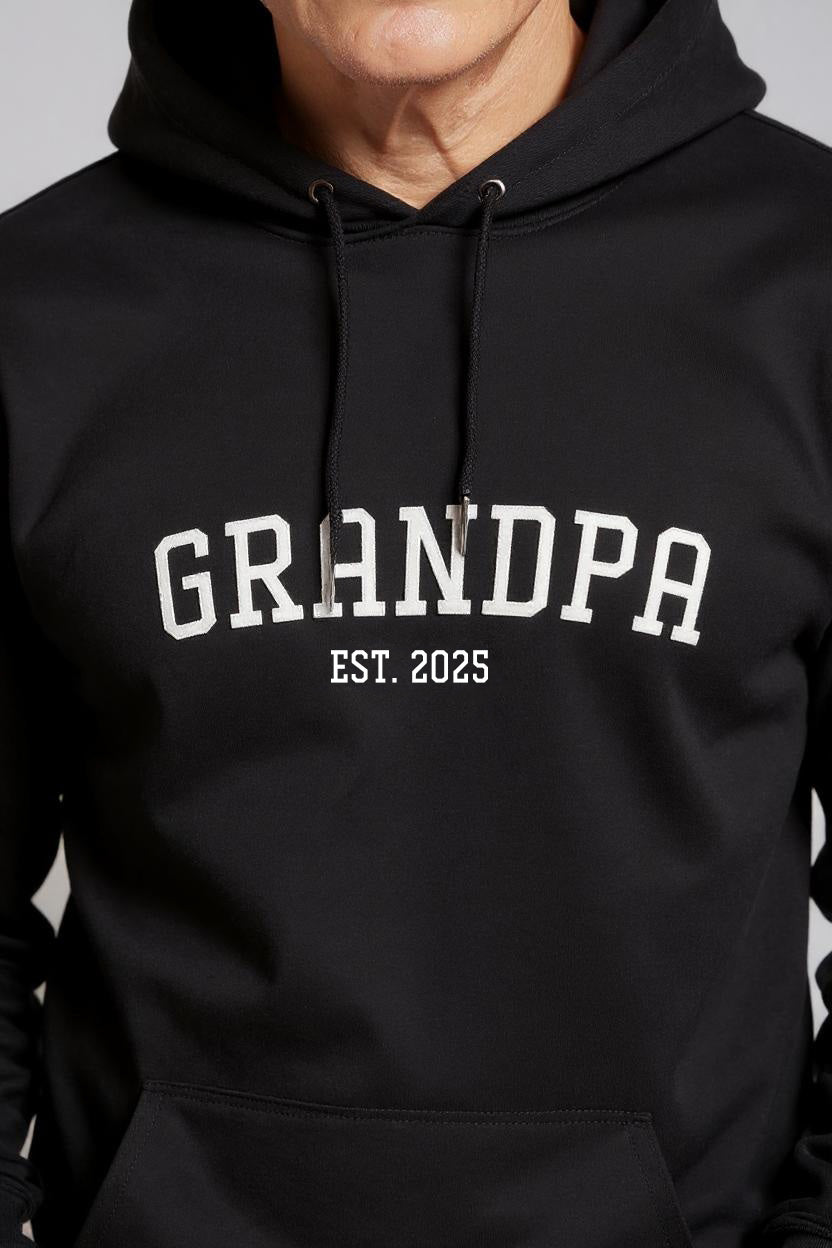 Black hoodie with 'GRANDPA EST. 2025' text on a gray background
