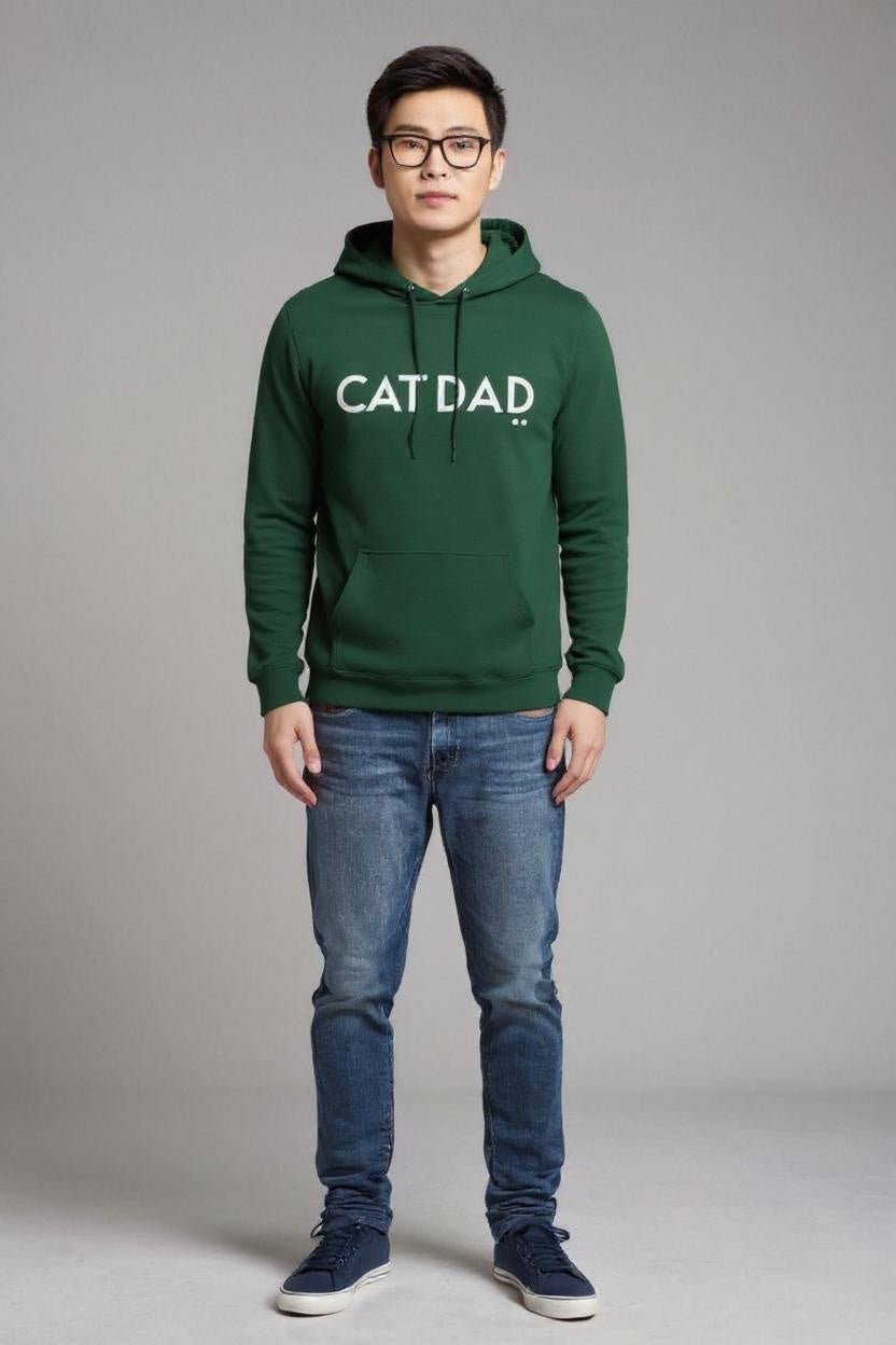 Person wearing a green hoodie with 'CAT DAD' text on a gray background