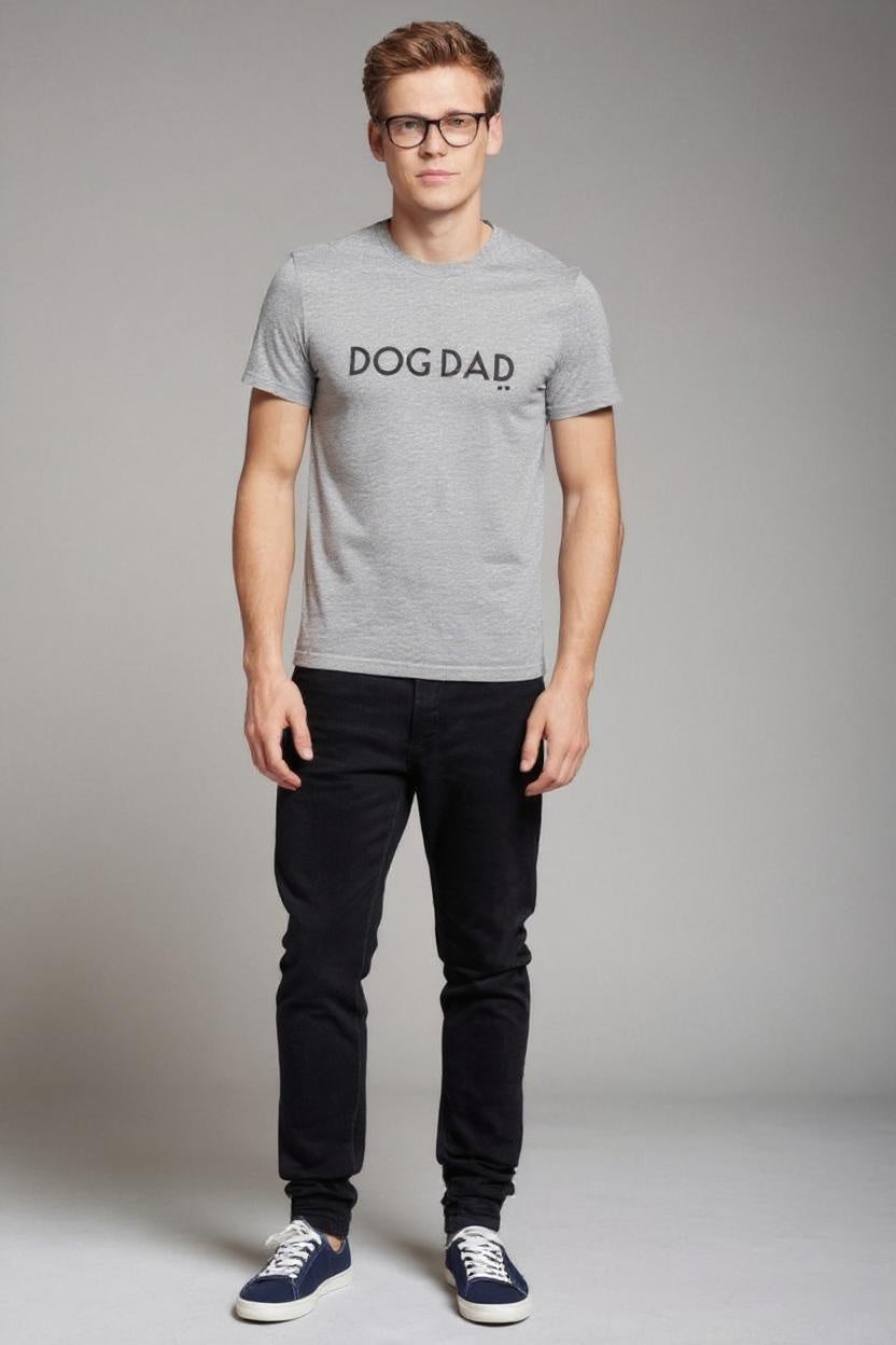 Man wearing a gray t-shirt with 'DOG DAD' text on a plain background