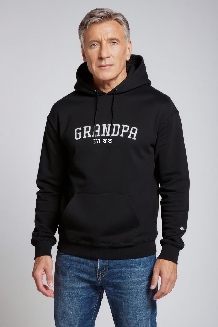 Man wearing a black hoodie with 'GRANDPA EST. 2023' text on a gray background