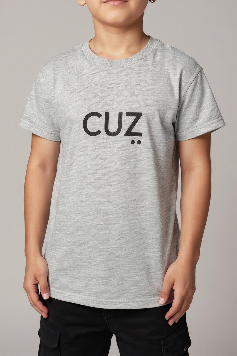 Child wearing a gray t-shirt with 'CUZ' printed on it against a plain background