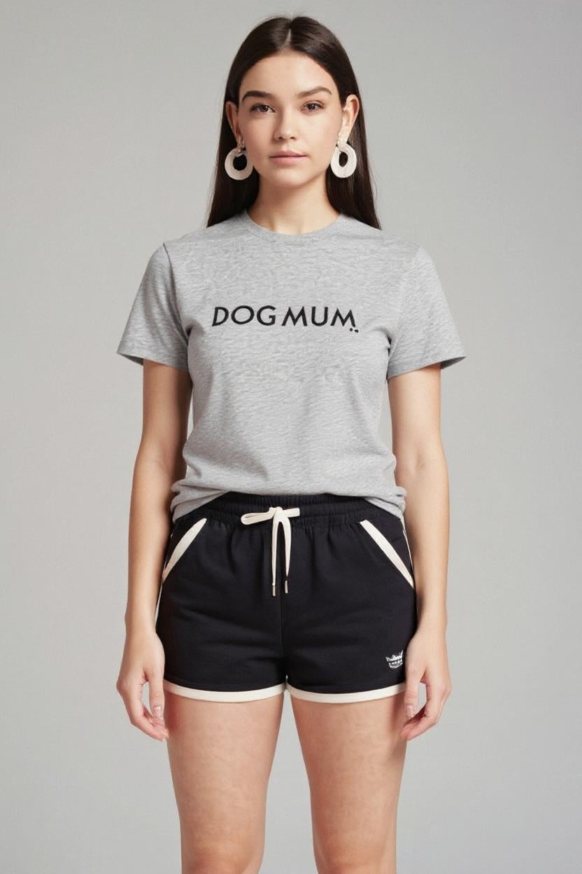 Woman wearing a gray 'DOG MUM' t-shirt and black shorts on a gray background
