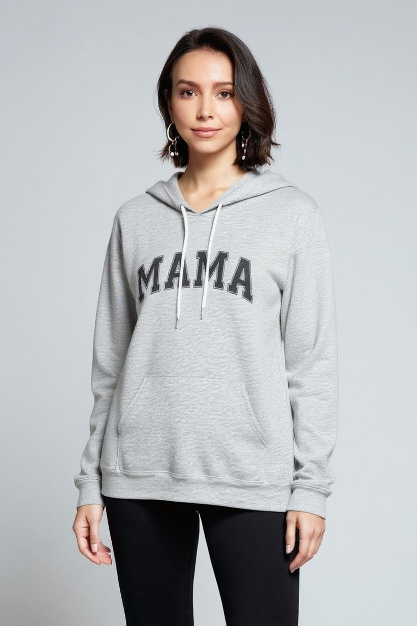 Woman wearing a gray hoodie with 'MAMA' printed on it against a plain background