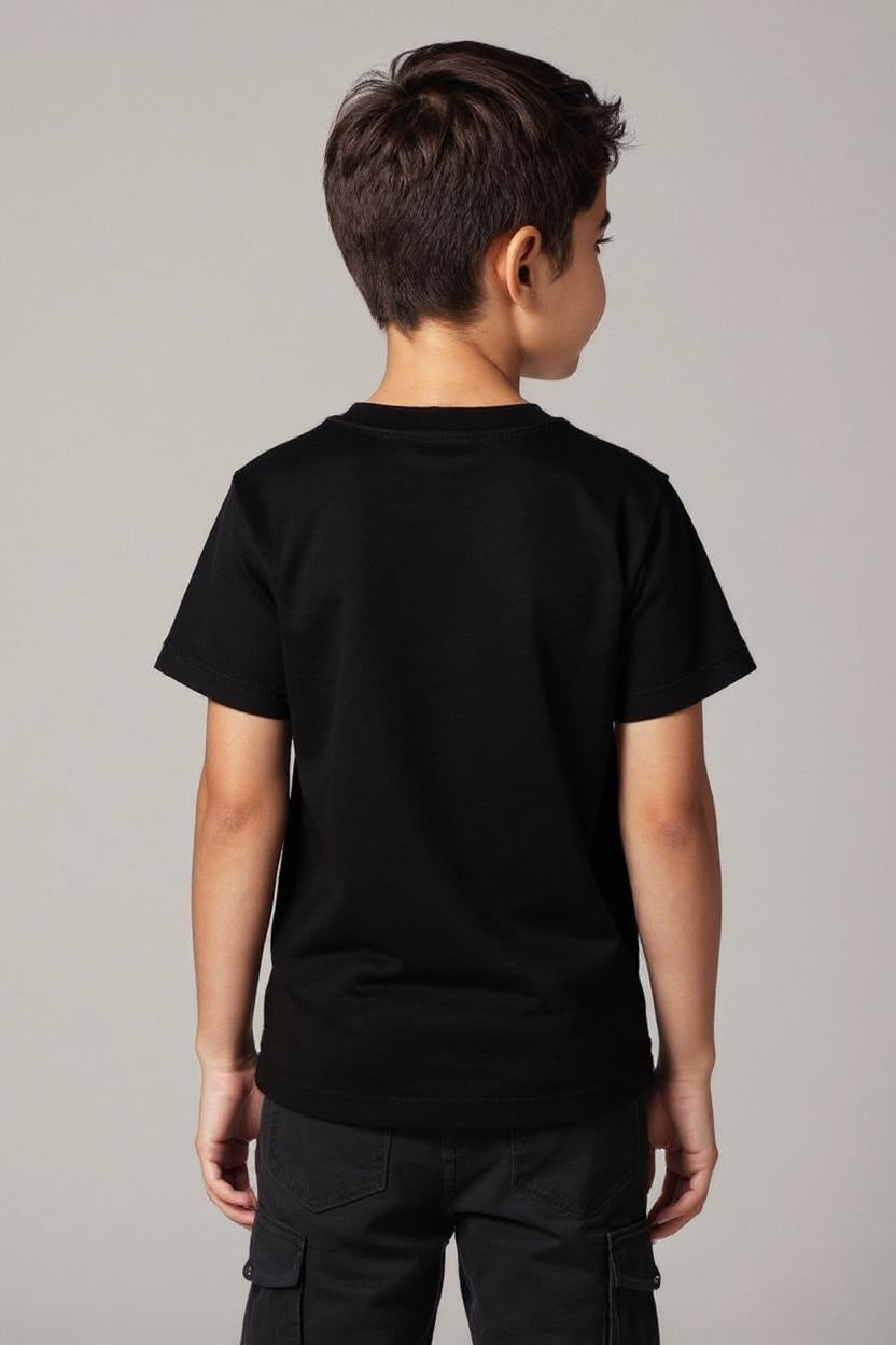 Child wearing a black t-shirt and pants on a plain background