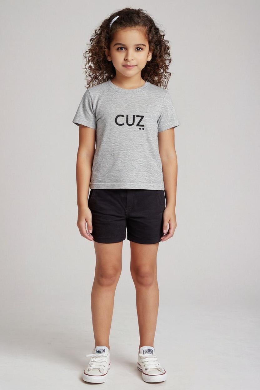 Young girl wearing a gray t-shirt with 'CUZ' printed on it against a plain background