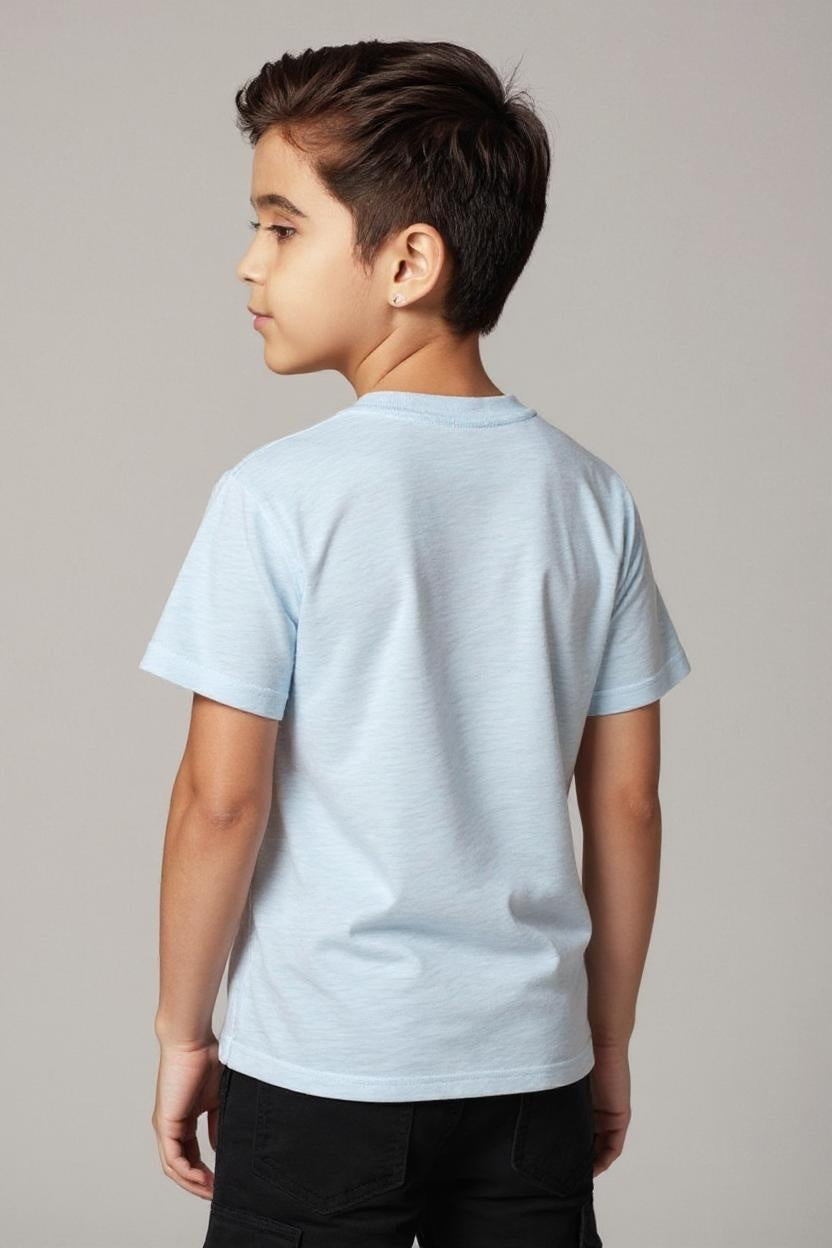 Child wearing a light blue t-shirt on a plain background