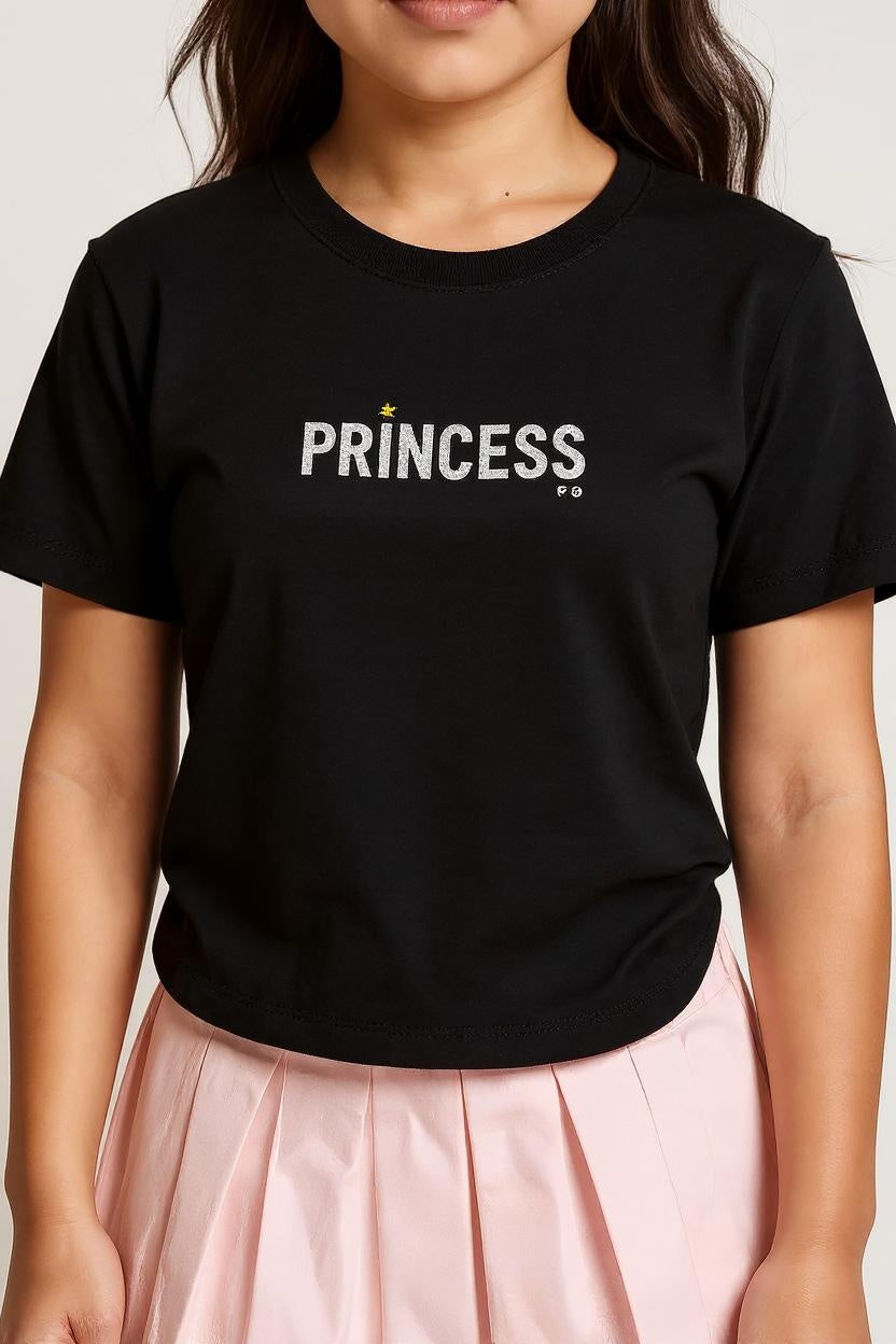 Person wearing a black t-shirt with 'PRINCESS' printed on it against a white background