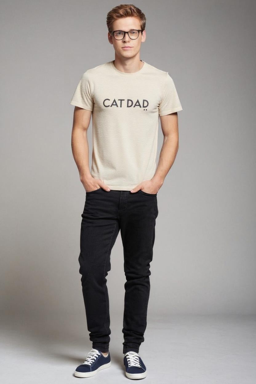 Man wearing a 'CAT DAD' t-shirt against a gray background