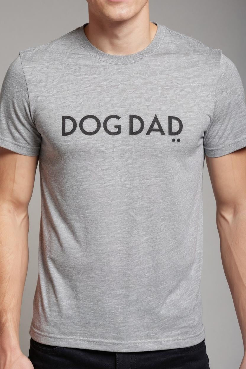 Person wearing a gray t-shirt with 'DOG DAD' text on a plain background