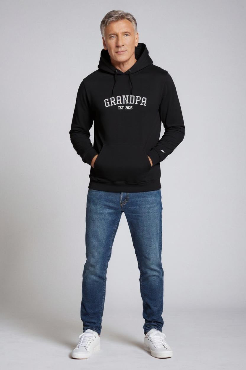 Man wearing a black hoodie with 'GRANDPA' text on a gray background