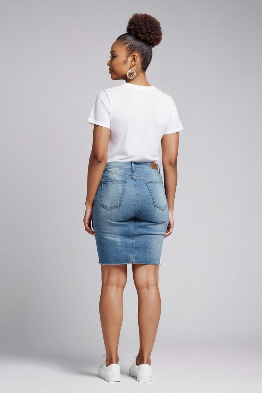 Person wearing a white t-shirt and blue denim skirt on a gray background