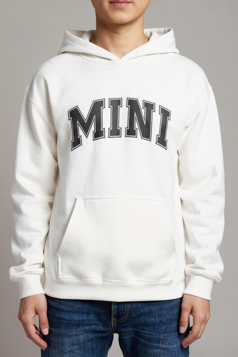 White hoodie with 'MINI' text worn by a person on a gray background