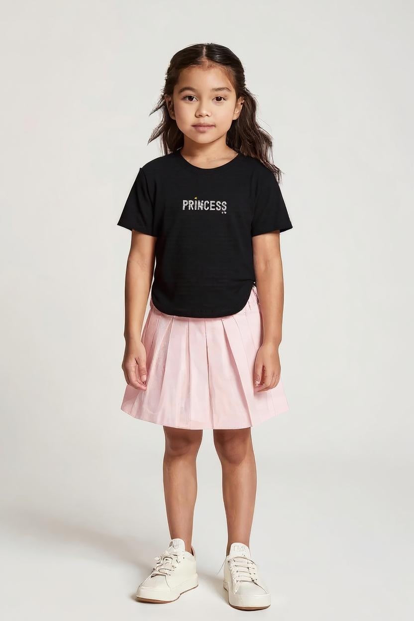 Young girl wearing a black t-shirt with 'PRINCESS' text and a pink skirt on a white background