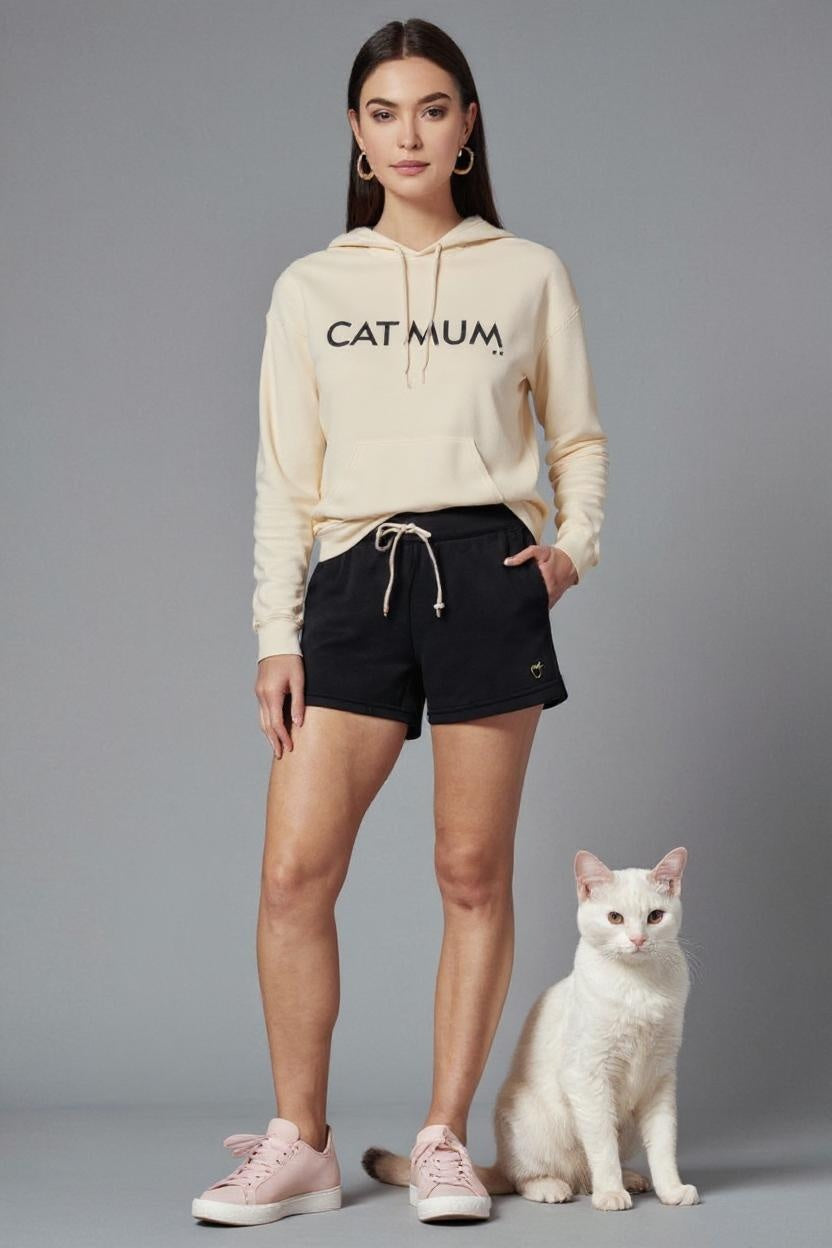 Woman wearing a hoodie with 'CAT MUM' text, standing next to a white cat on a gray background