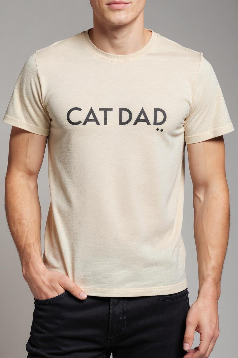 Person wearing a beige t-shirt with 'CAT DAD' text on a gray background