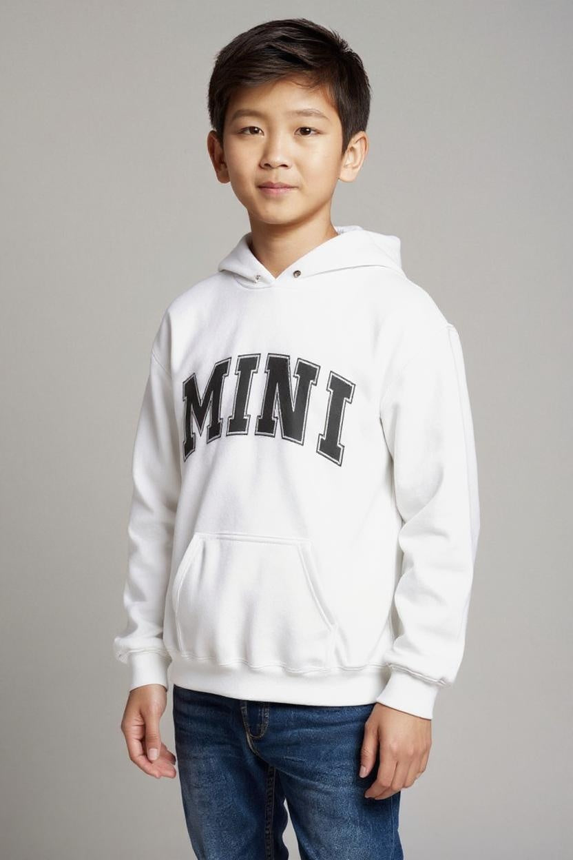 Child wearing a white hoodie with 'MINI' printed on it against a gray background