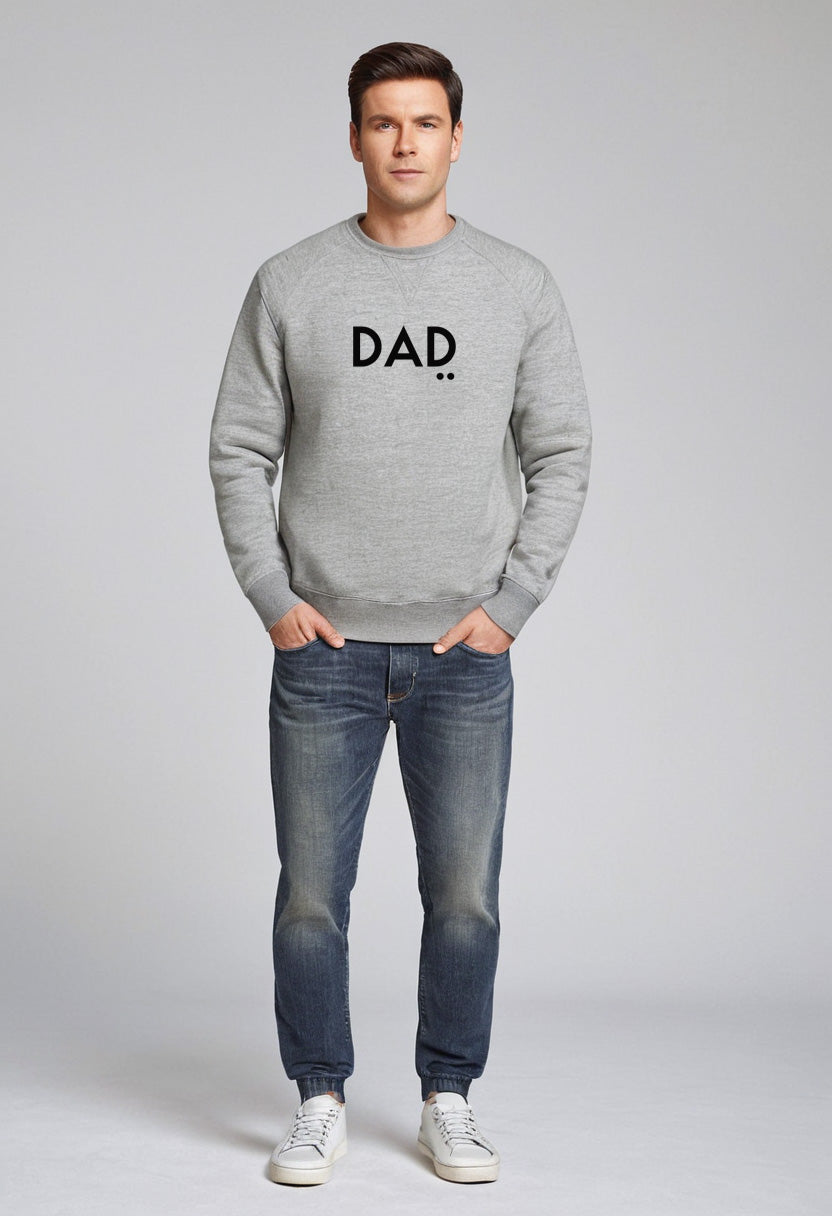Man wearing a gray sweatshirt with 'DAD' printed on it against a plain background