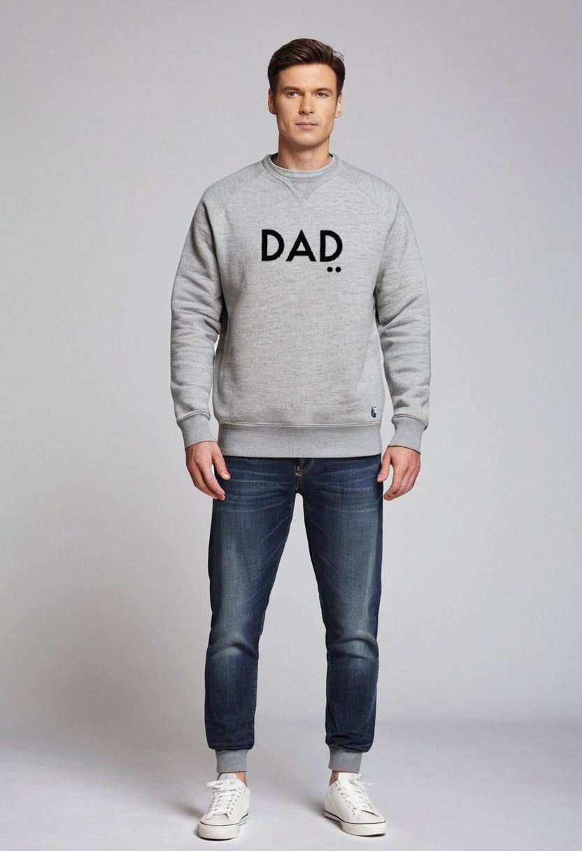 Man wearing a gray sweatshirt with 'DAD' printed on it against a plain background