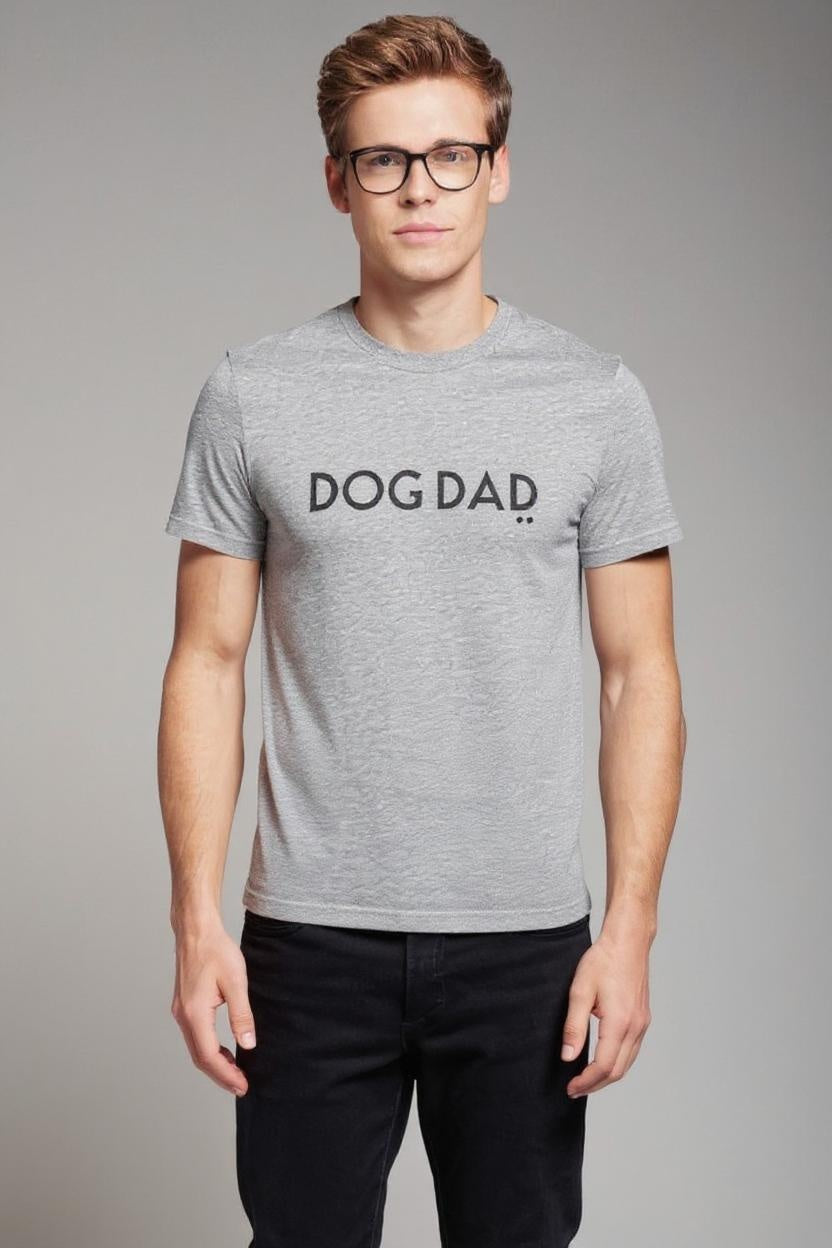 Man wearing a gray t-shirt with 'DOG DAD' text on a plain background