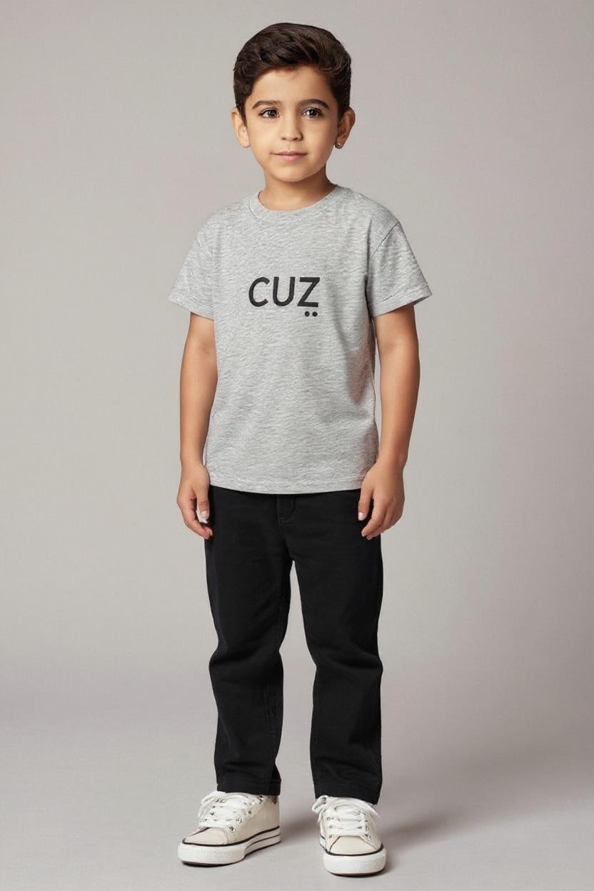 Child wearing a gray t-shirt with 'CUZ' text on a plain background