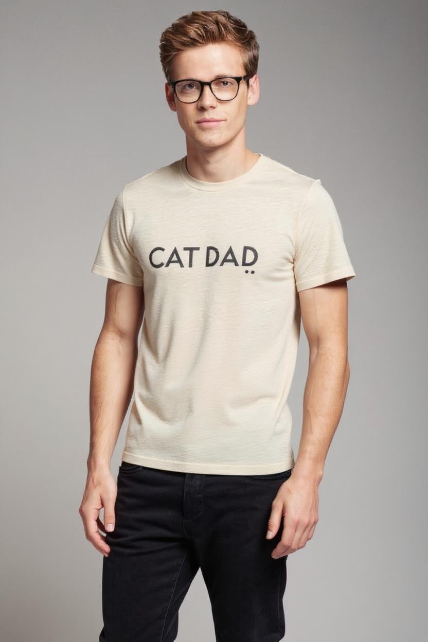 Man wearing a beige t-shirt with 'CAT DAD' text on a gray background