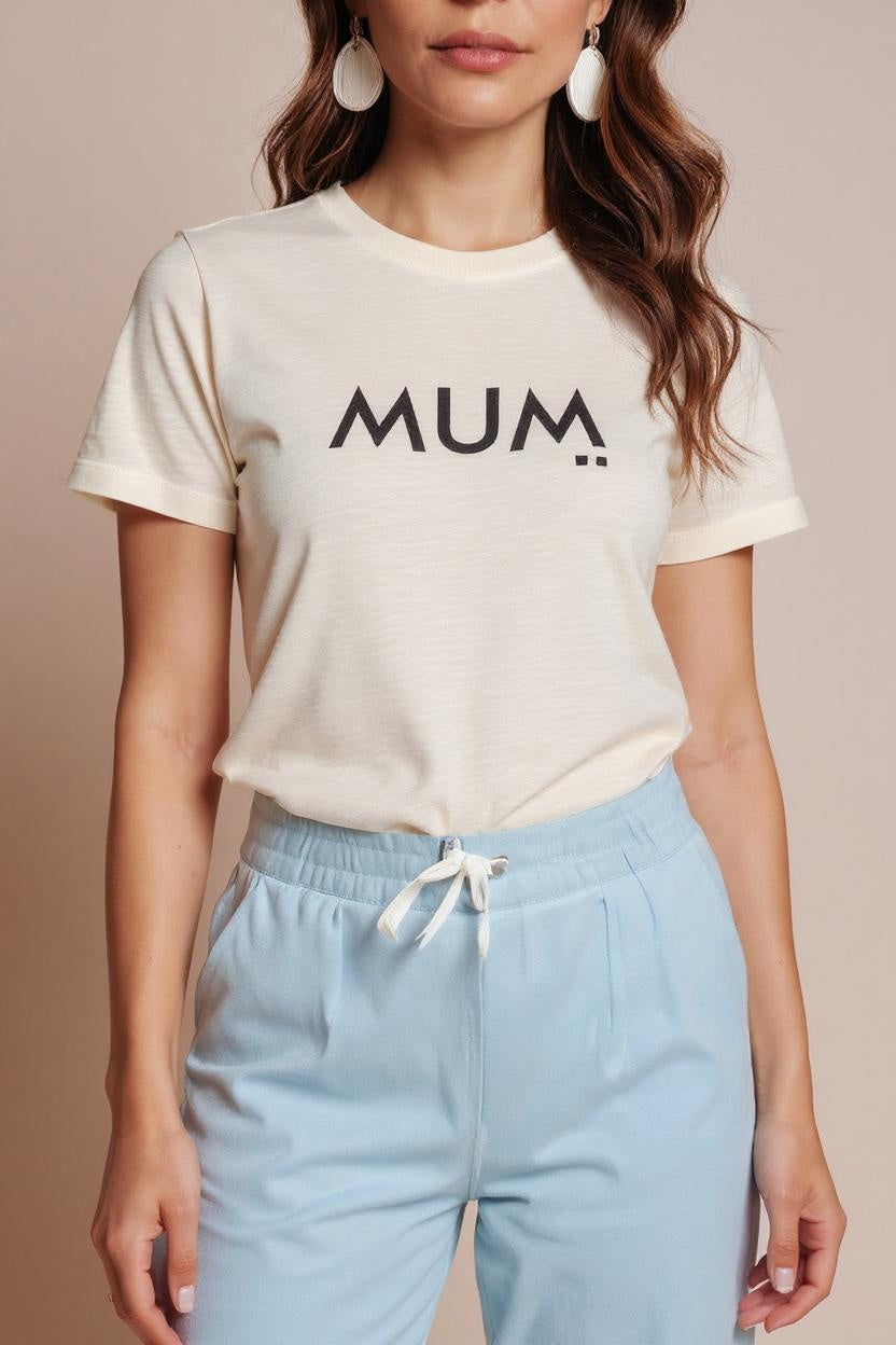 Person wearing a white t-shirt with 'MUM' printed on it and light blue pants.