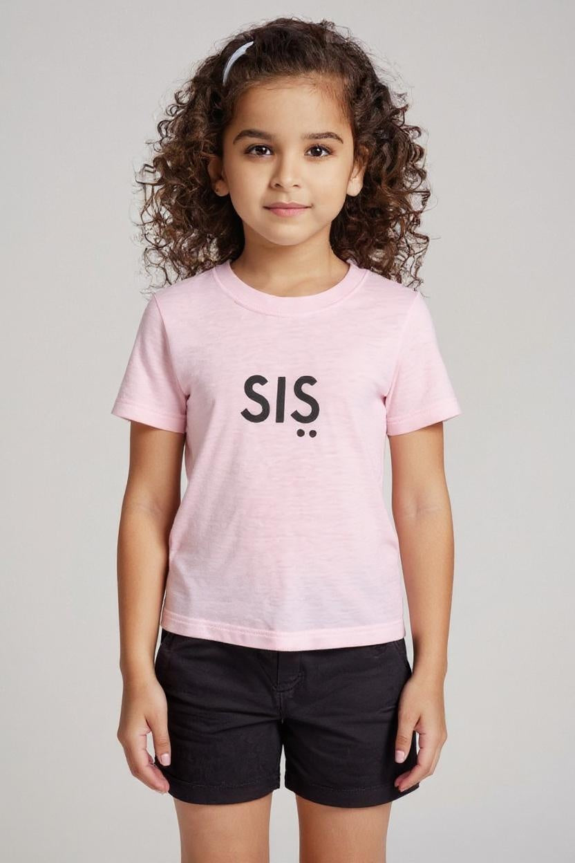 Child wearing a pink t-shirt with 'SIS' on a plain background