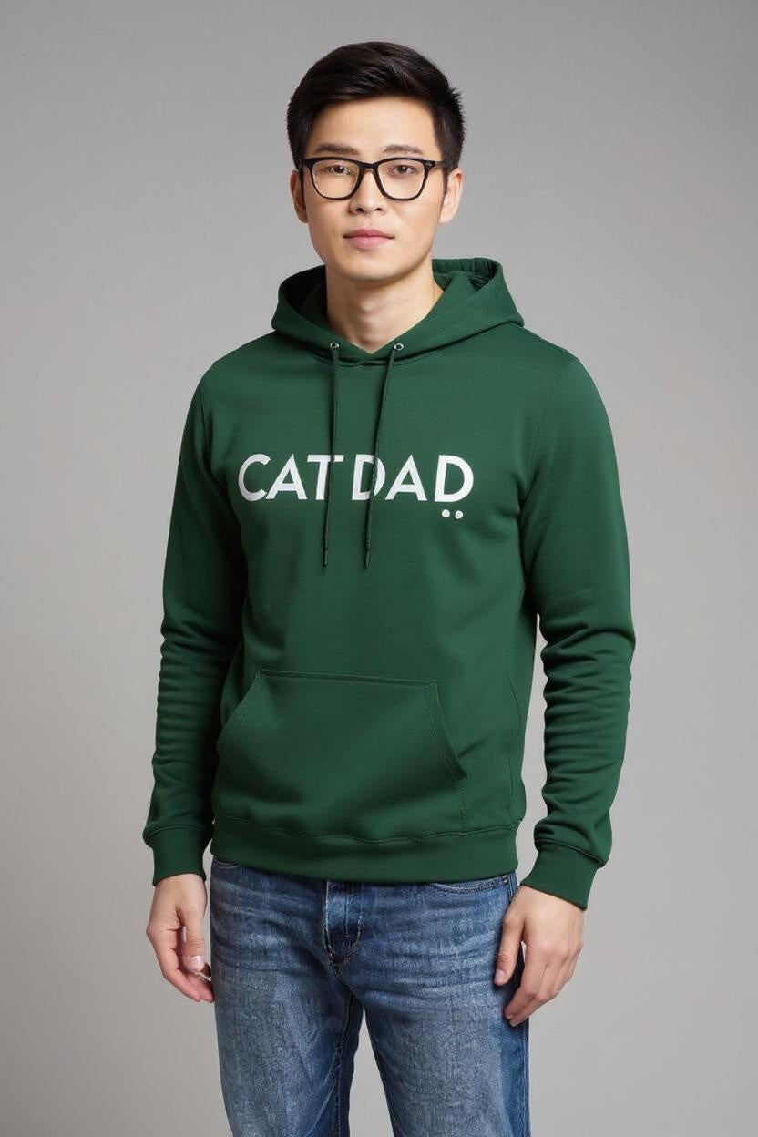 Person wearing a green hoodie with 'CATDAD' text on a gray background