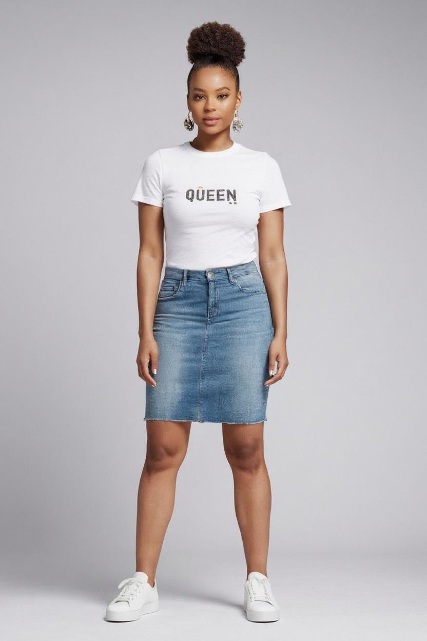 Woman wearing a white t-shirt with 'QUEEN' text and a denim skirt on a gray background