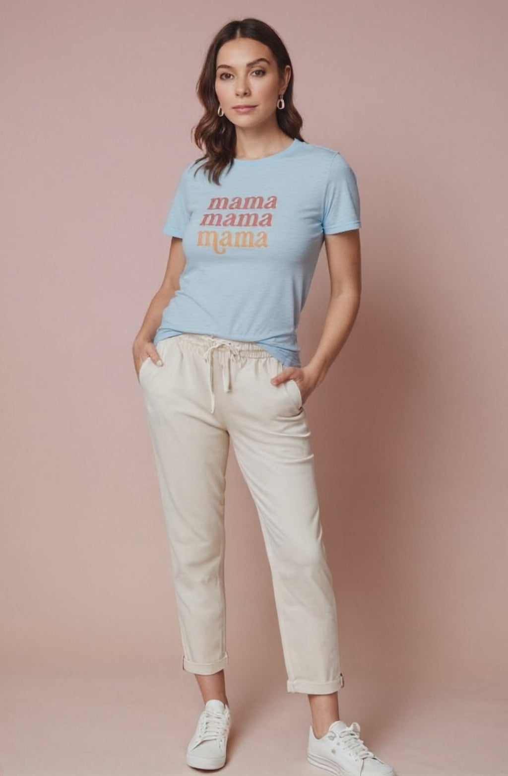 Woman wearing a light blue t-shirt with 'mama' text on a pink background